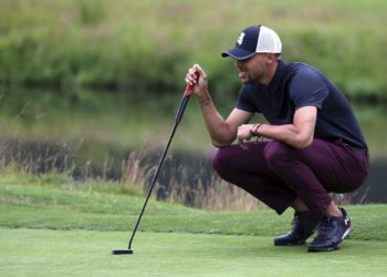 Golden State Warriors All-Star guard Stephen Curry lines up a putt on the first green during the first round at the American Century Golf Championship, Friday, July 13, 2018, at the Edgewood Tahoe Golf Course in Stateline, Nev. (AP Photo/Lance Iversen)