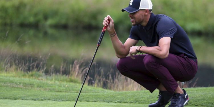Golden State Warriors All-Star guard Stephen Curry lines up a putt on the first green during the first round at the American Century Golf Championship, Friday, July 13, 2018, at the Edgewood Tahoe Golf Course in Stateline, Nev. (AP Photo/Lance Iversen)